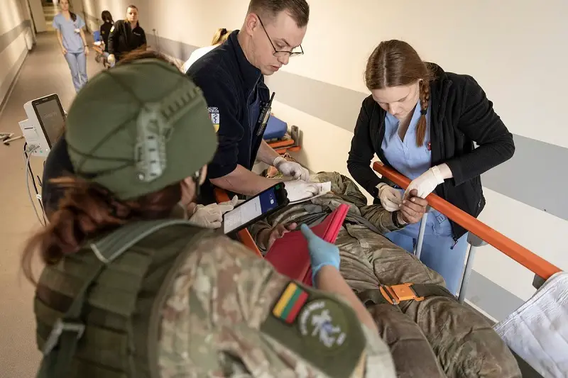 Military and civilian medical personnel perform simulated patient care on a casualty during exercise Iron Wolf. The exercise laid stress on military-civilian integrated cooperation, including in medical field 