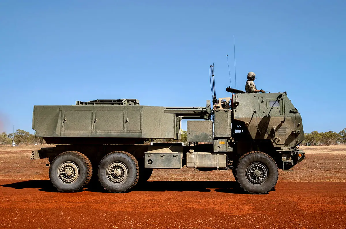 A United Stated Army crewman commands a United States Army M142 High Mobility Artillery Rocket System (HIMARS) to the firing point at Delamere Air Weapons Range, Northern Territory.
