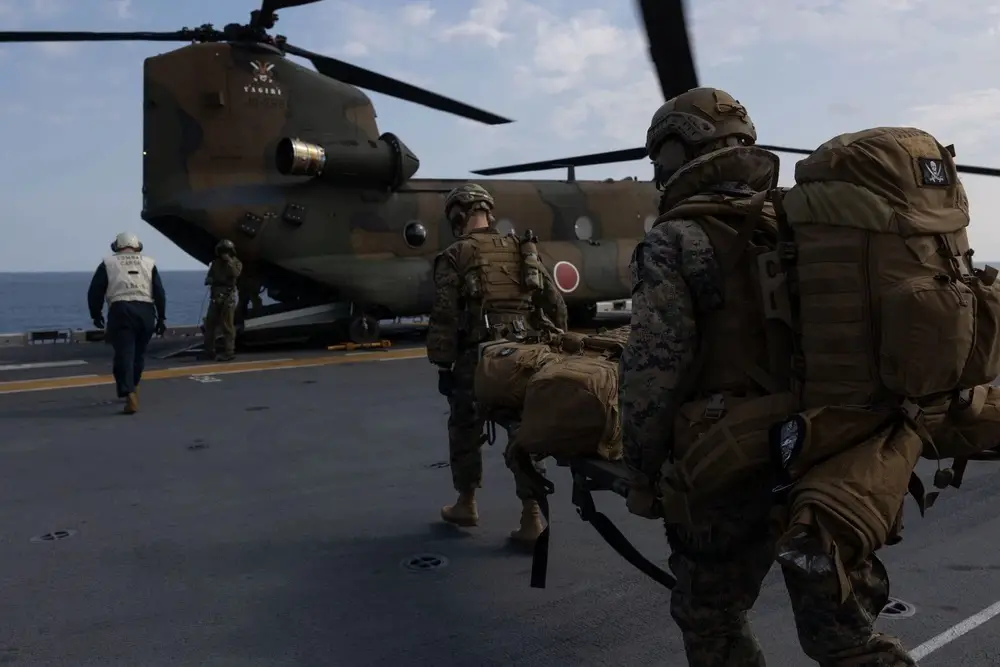 U.S. Navy medical personnel with command element, 31st Marine Expeditionary Unit board a Japan Ground Self Defense Force Boeing CH-47JA Chinook during an en route care exercise for Iron Fist 24, aboard the amphibious assault ship USS America (LHA 6), in the Western Pacific, March 14, 2024.