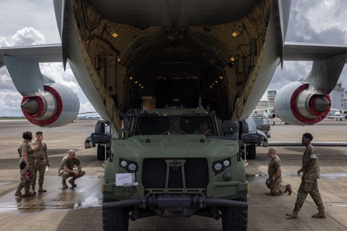 U.S. Marines and Japan Air Self-Defense Force members load a joint light tactical vehicle into a Kawasaki C-2 during a loading test on Japan Air Self-Defense Force Iruma Air Base, Sayama, Japan, Aug. 28, 2024. 