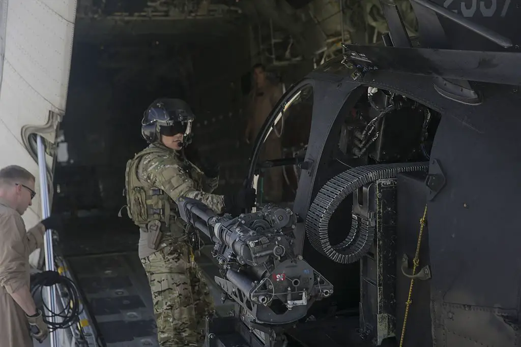 Boeing AH-6X with a GAU-19, being loaded into a KC-130J