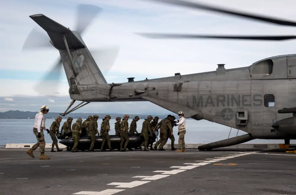 Japan Ground Self-Defense Force soldiers load a combat rubber raiding craft aboard a CH-53E Super Stallion, assigned to the 