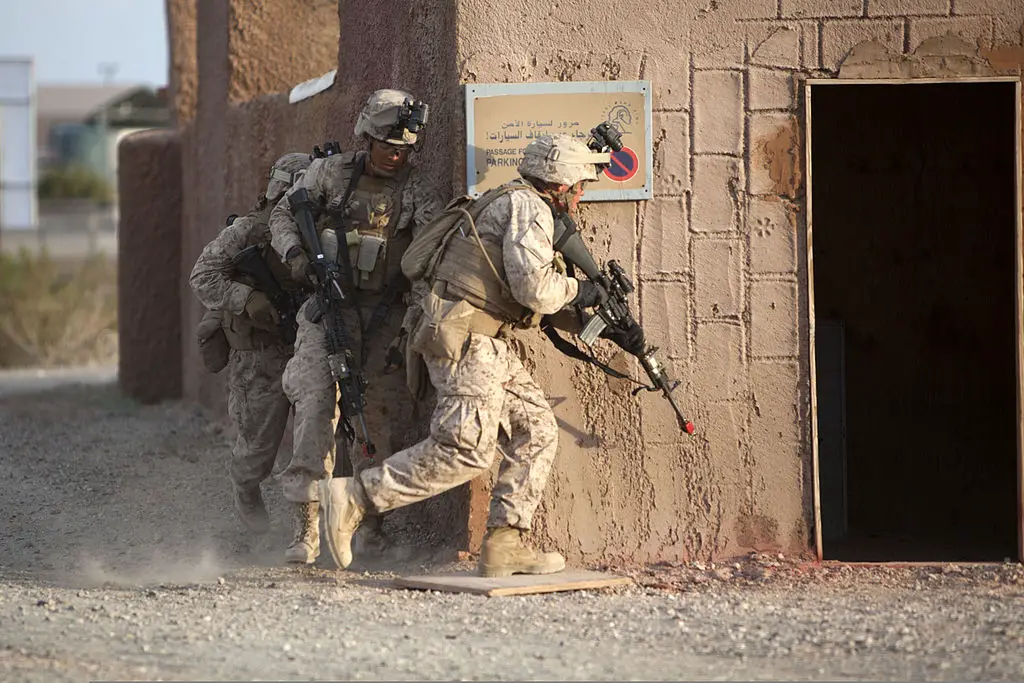 Marines prepare to breach a building during a mock helicopter raid at Yuma Proving Ground  