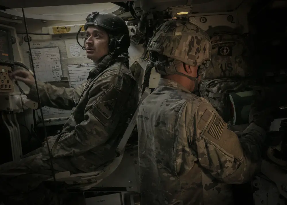 Staff Sgt. Jorge Almeraz (left), tank commander and Sgt. Antonio Bello (right), a canon crewmember, both with the Battery B, 4th Battalion, 1st Field Artillery Regiment, resets their stations after a nine round fire mission inside of a M109A6 Paladin during the Joint Strike Fighter Integration exercise, Nov. 7, at the Dona Ana Training Facility in New Mexico. The JSF Integration exercise tested multiple communications links between a U.S. Air Force aircraft and a U.S. Army artillery battery from the 1st Armored Division, to increase readiness across multiple domains. (U.S. Army photo by Staff Sgt. Brandon Banzhaf, 24th Theater Public Affairs Support Element)