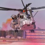 Colored oil smoke indicates rotor wake and wind effects while external â€œtuftsâ€ adhere to the outside of the CH-53K King Stallion showing surface airflow. These efforts validate a modification mitigating Exhaust Gas Re-ingestion for the new Marine Corps aircraft. US Navy photo.