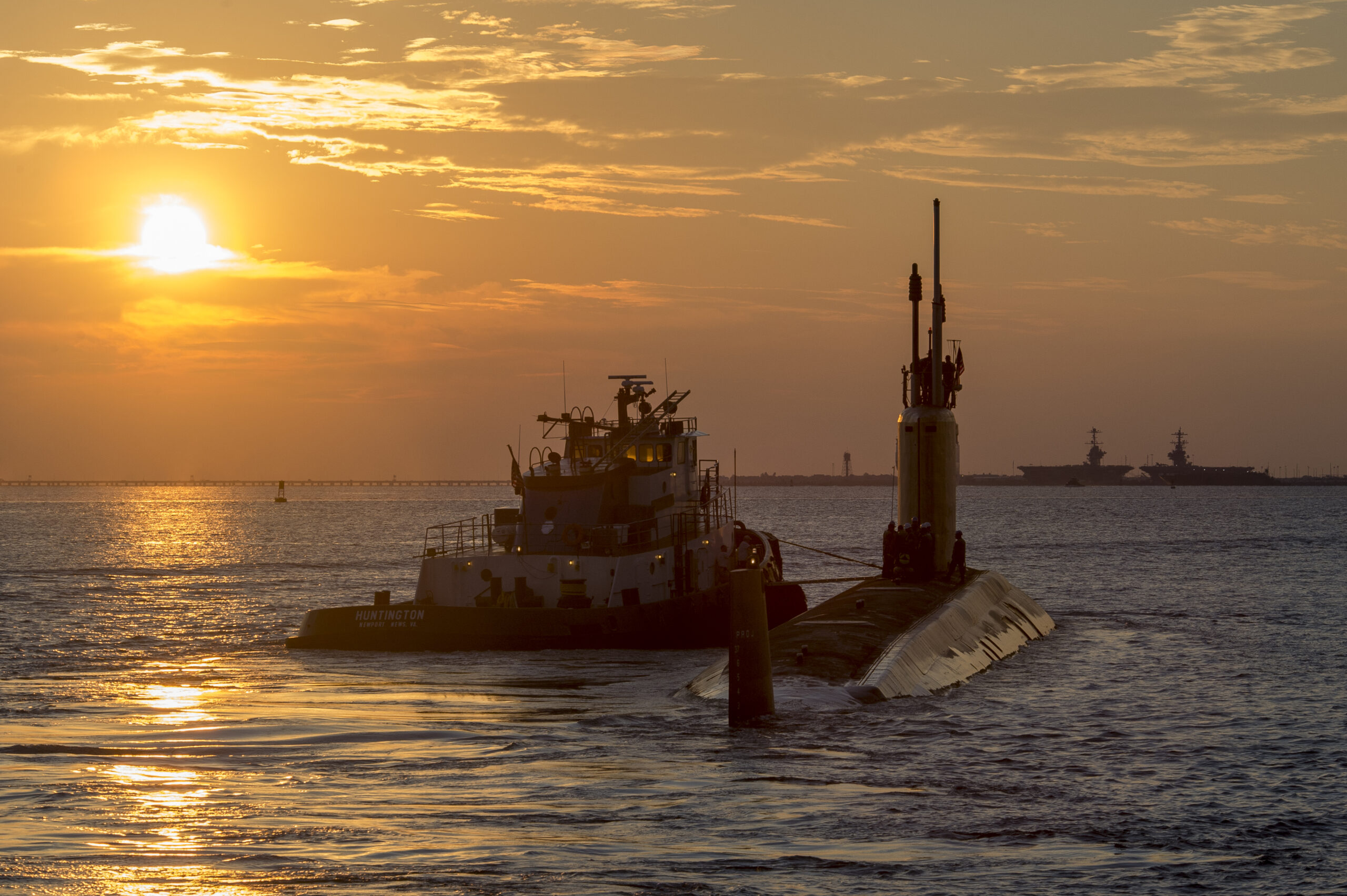 The submarine USS John Warner (SSN 785) is pictured leaving Newport News Shipbuilding on sea trials as part of its post shakedown availability. It is the first PSA to be accomplished without having to put the boat into a dry dock for external hull work. Photo by John Whalen/HII