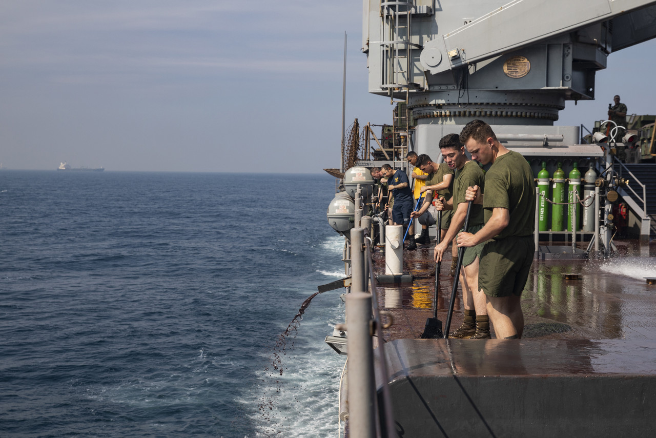 U.S. Marines and Sailors sweep aboard the USS Germantown (LSD 42) at Bay of Bengal on November 17, 2019. The Marines and Sailors clean the ship to maintain cleanliness and serviceability after visiting Visakhapatnam, India for exercise Tiger TRIUMPH. The exercise is an opportunity for professional and cultural exchanges, teamwork, expanding common ground, learning, training and increasing friendship between the U.S. and Indian militaries. The Marines are with 3rd Marine Division, III Marine Expeditionary Force. (U.S. Marine Corps photo by Lance Cpl. Armando Elizalde)