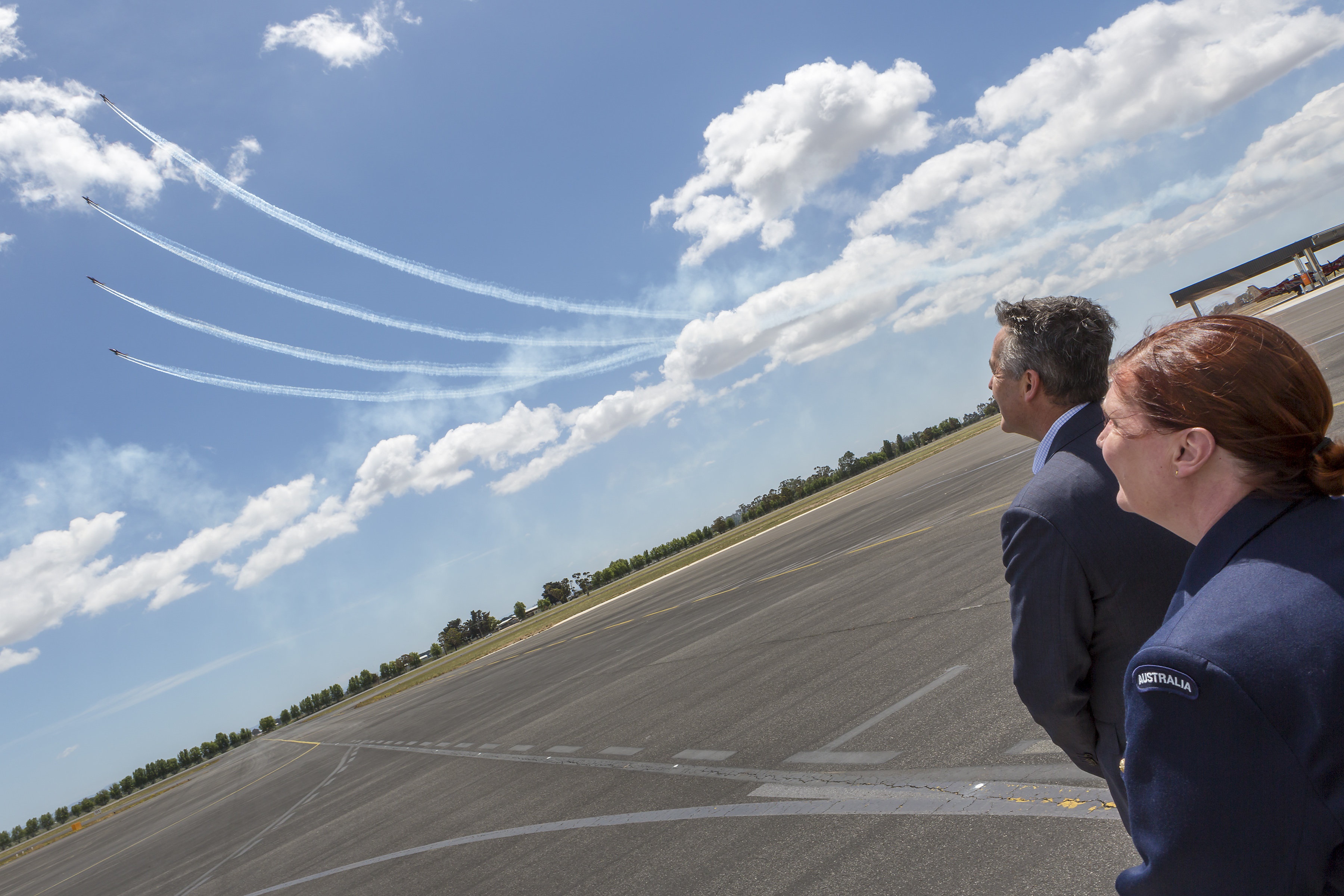 Minister for Veterans and Defence Personnel, the Hon. Darren Chester MP (r), and Air Vice-Marshal Catherine Roberts, Head of Air Force Capability watch the new Pilatus PC-21 roulettes perform a display over RAAF Base East Sale. 