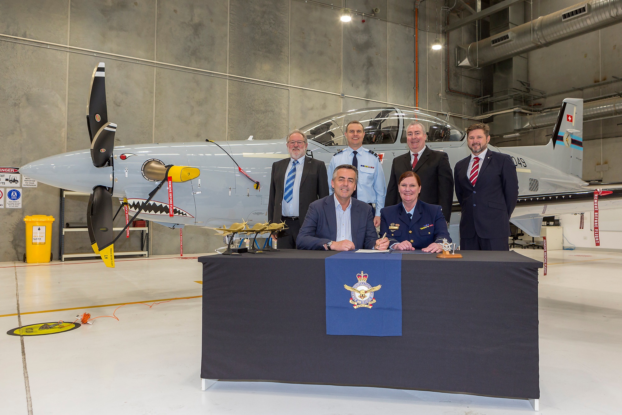 Minister for Veterans and Defence Personnel, the Hon. Darren Chester MP (r), and Air Force officer, Head of Air Force Capability, Air Vice-Marshal Catherine Roberts, sign the Certificate of Achievement at the final delivery ceremony for the new RAAF Pilatus PC-21s at RAAF Base East Sale.