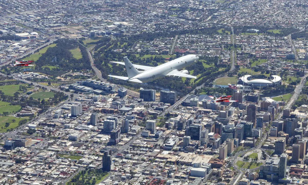 Two Air Force PC-9/A aircraft alongside a P-8A Poseidon, conduct a flypast over Adelaide, South Australia. 