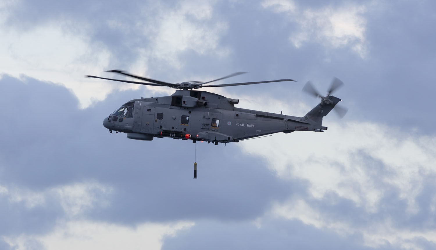 A mark 2 Anti Submarine Warfare Merlin helicopter from 820 Naval Air Squadron, drops its sonar into the Atlantic during an exercise off the East coast of the USA.