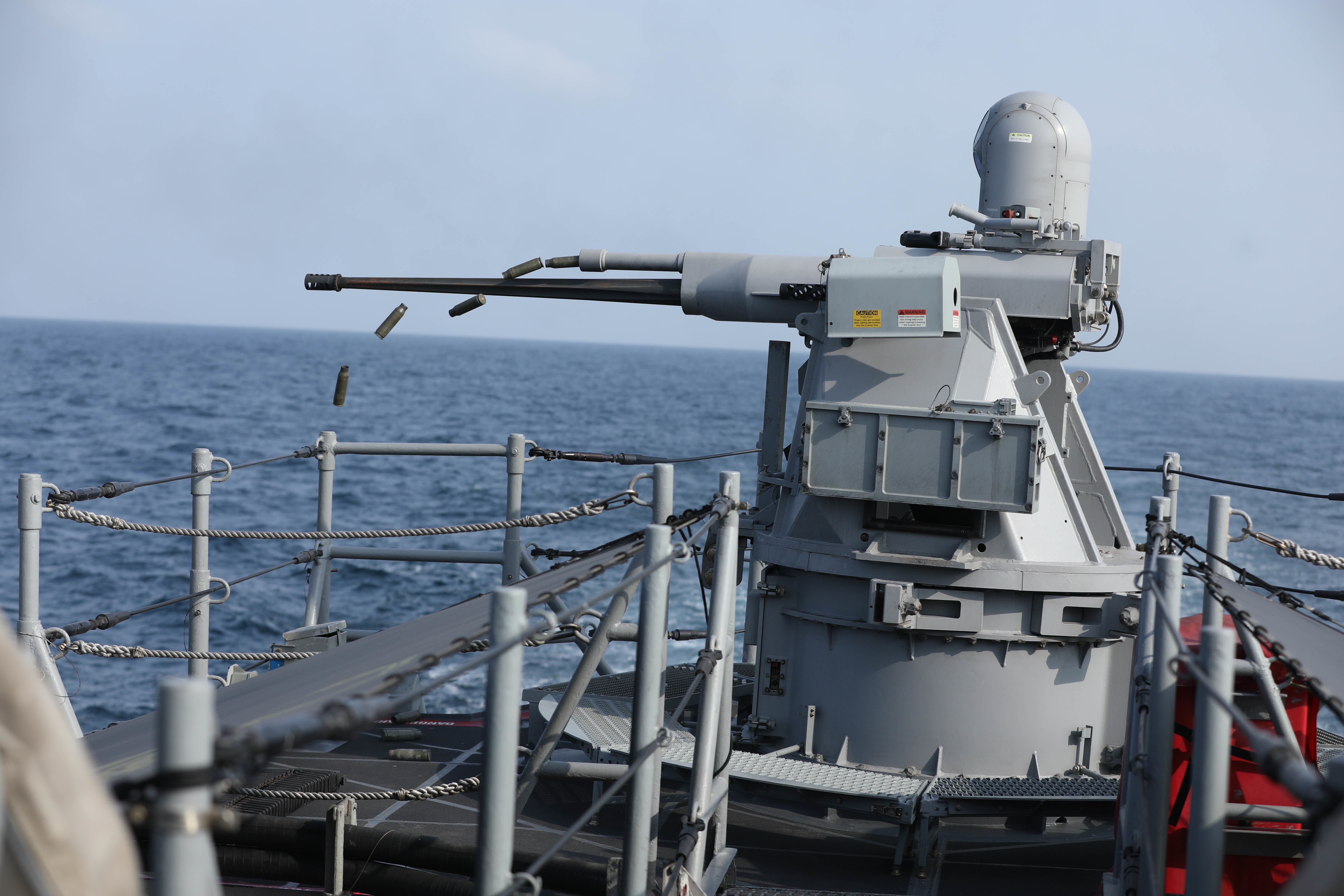 A MK-38 machine gun aboard the coastal patrol ship USS Sirocco (PC 6) fires rounds at simulated enemy ships as part of Griffin Missile Exercise 19. The exercise demonstrated a proven capability for the ships to defend themselves against small boat threats and ensure maritime security through key chokepoints in the U.S. Central Command area of responsibility. 