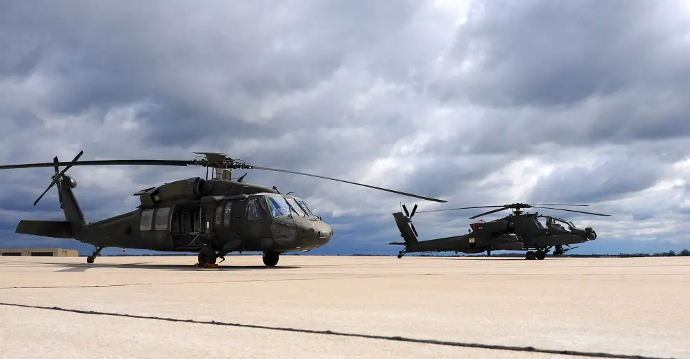 A Missouri Army National Guard UH-60 Black Hawk utility helicopter, left, sits next to an AH-64 Apache attack helicopter on the flightline at Whiteman Air Force Base, Mo., April 1, 2016. Black Hawk helicopters began arriving at the 1-135th Attack Reconnaissance Battalion in September of 2015 as part of the Department of the Army's Aviation Reconstruction Initiative. There are now 13 Apaches and 10 Black Hawks assigned to the unit.