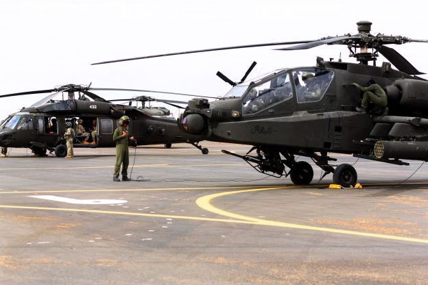 U.S. soldiers prepare AH-64 Apache and UH-60 Black Hawk helicopters before a practice joint air assault exercise with Saudi soldiers near Tabuk, Saudi Arabia,