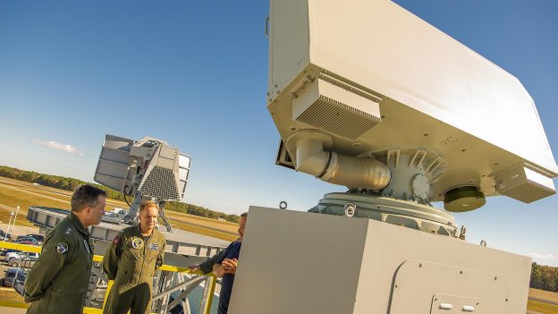 Rear Adm. Shane Gahagan, Program Executive Officer for Program Executive Office Tactical Aircraft Programs (PEO(T)) (left), and Capt. Kevin Watkins, Naval Air Traffic Management Systems Program Office (PMA-213) program manager (center), see a new Shipboard Air Traffic Radar, AN/SPN-50, that is being used for the radar's engineering and manufacturing development phase during a demonstration at Naval Air Warfare Center Aircraft Division Webster Outlying Field on Oct. 23, 2019.