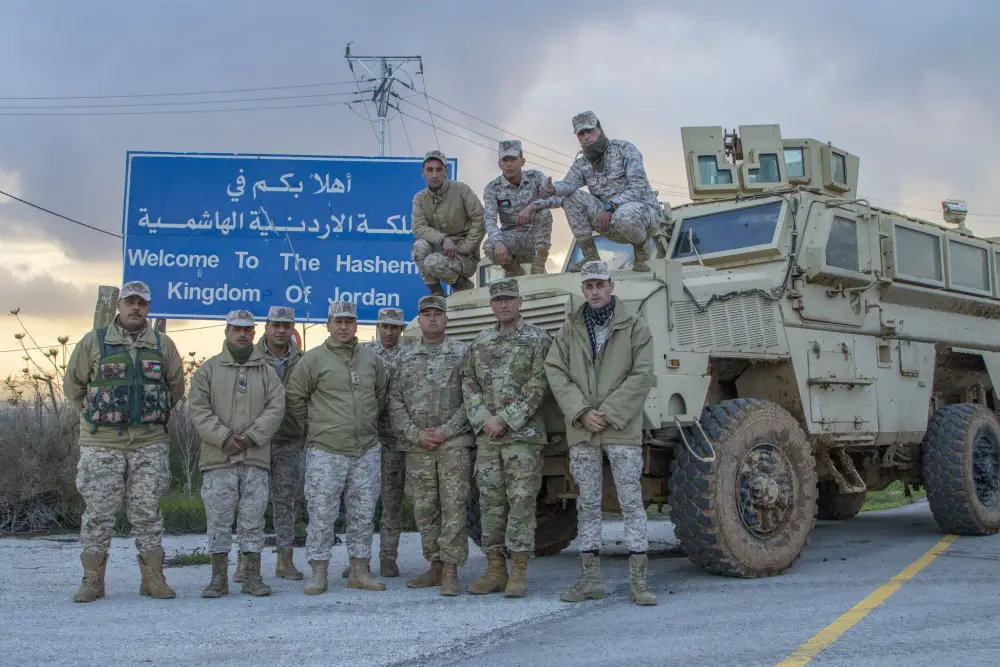 Jordan Armed Forces-Arab Army (JAF) Soldiers pose for a photo with Arizona Army National Guard, during a Mine Resistant Ambush Protected Wheeled Armor Vehicle at a base outside of Amman, Jordan in January. 