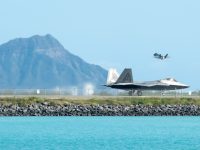 A Hawaii Air National Guard F-22 Raptor taxis down the Honolulu Airport Runway Jan. 29, 2020, as an F-35A Lightning II takes off.