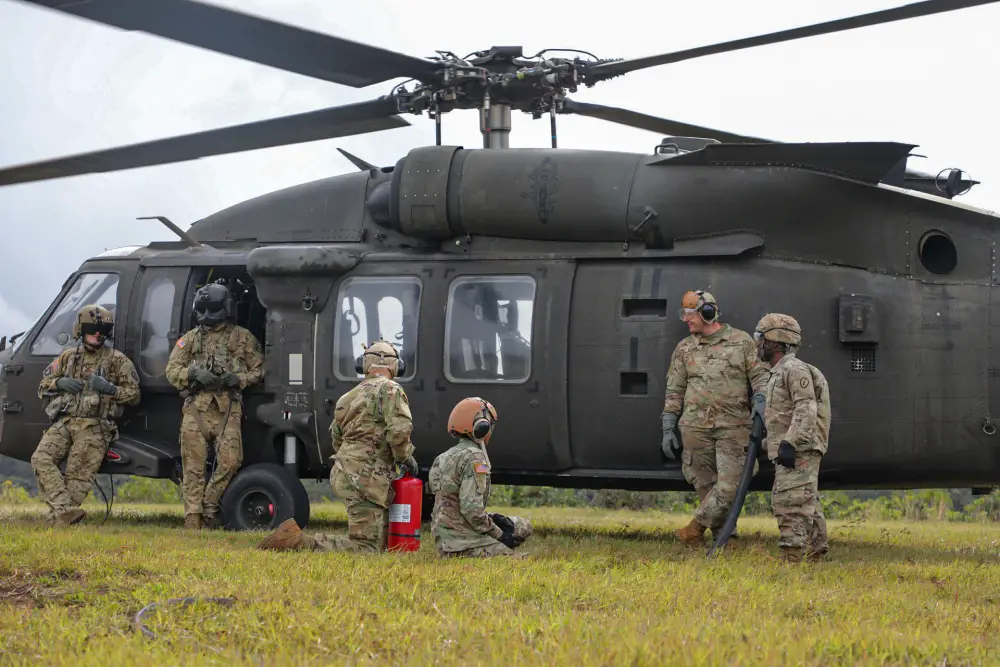 Petroleum Supply Specialists work together to refuel three Black hawksduring training in FATCOW procedures.