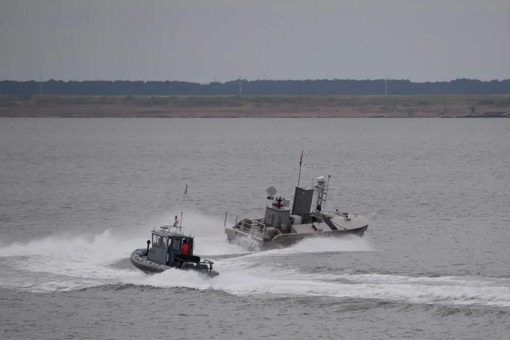 A developmental, early variant of the Common Unmanned Surface Vehicle (CUSV) autonomously conducts maneuvers on the Elizabeth River during its demonstration during Citadel Shield-Solid Curtain 2020 at Naval Station Norfolk. (U.S. Navy photo by Mass Communication Specialist 3rd Class Rebekah M. Rinckey/Released)