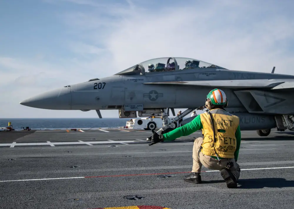  Chief Aviation Boatswain's Mate (Handling) Louis Mountain, from Seat Pleasant, Maryland, assigned to USS Gerald R. Ford's (CVN 78) air department, signals an F/A-18F Super Hornet, attached to "Black Lions" of Strike Fighter Squadron (VFA) 213, on Ford's flight deck during flight operations. Ford is currently underway conducting its flight deck and combat air traffic control center certifications. (U.S. Navy photo by Mass Communication Specialist 3rd Class Zachary Melvin)