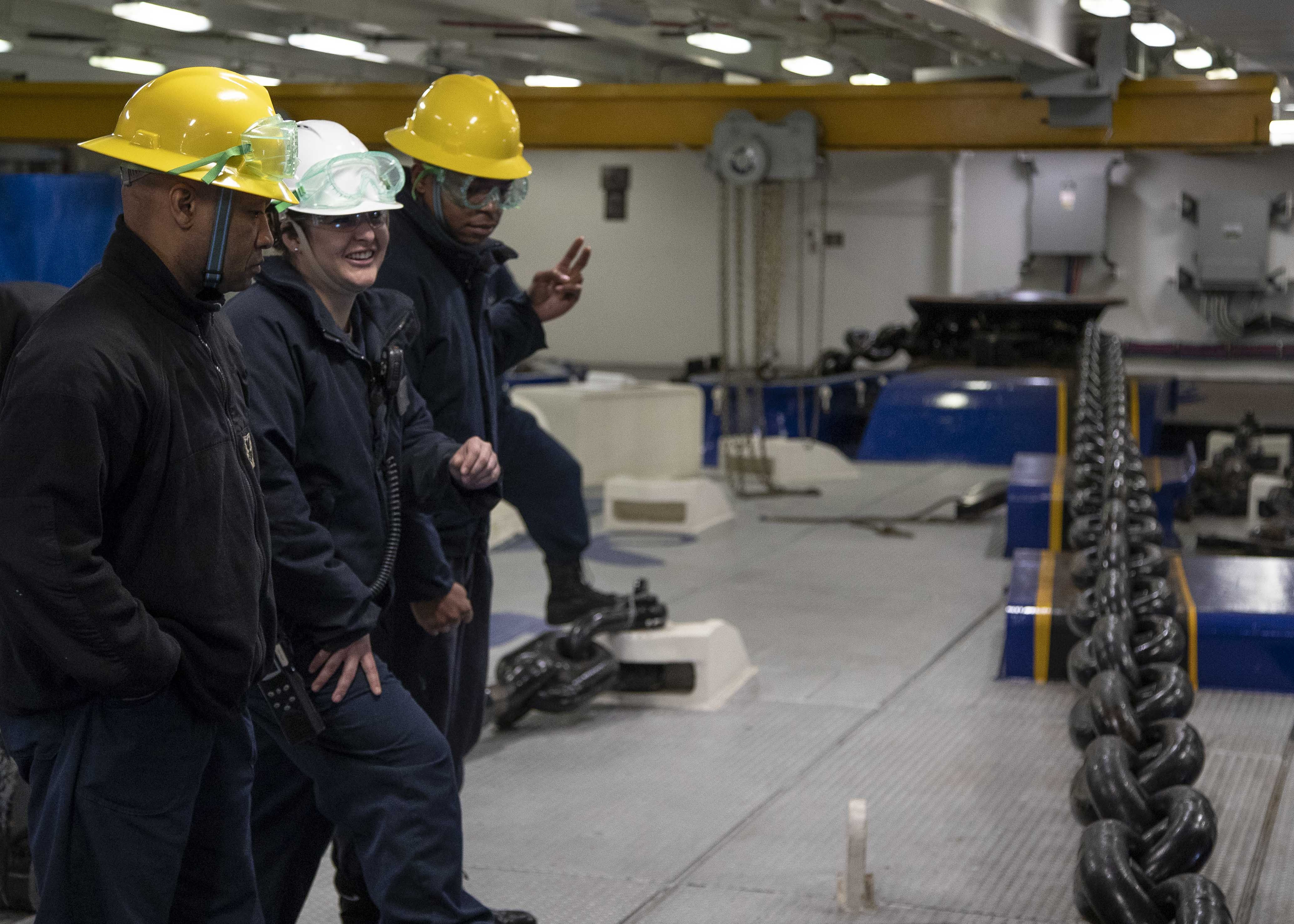 Sailors assigned to the deck department of the aircraft carrier USS Gerald R. Ford (CVN 78) participate in an anchoring evolution in the ship's forecastle.