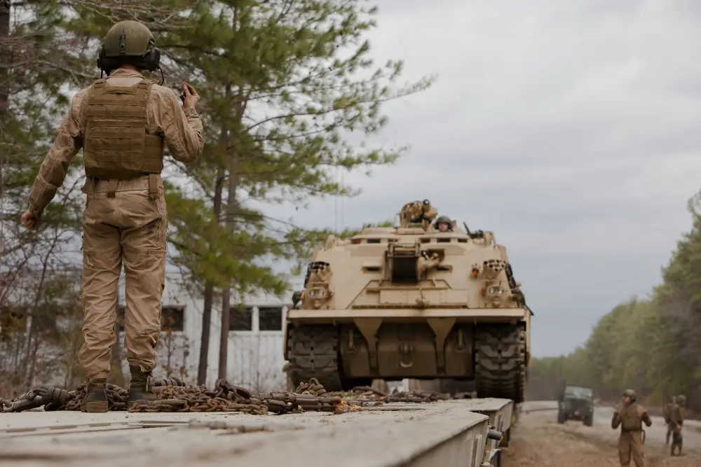 U.S. Marine Corps Cpl. Ryan Goetts, a vehicle commander, 2nd Tank Battalion, 2nd Marine Division, ground guides an M88 A2 Hercules Recovery Vehicle off railcars during a Deployment for Training (DFT) Exercise at Fort Pickett, Va.
