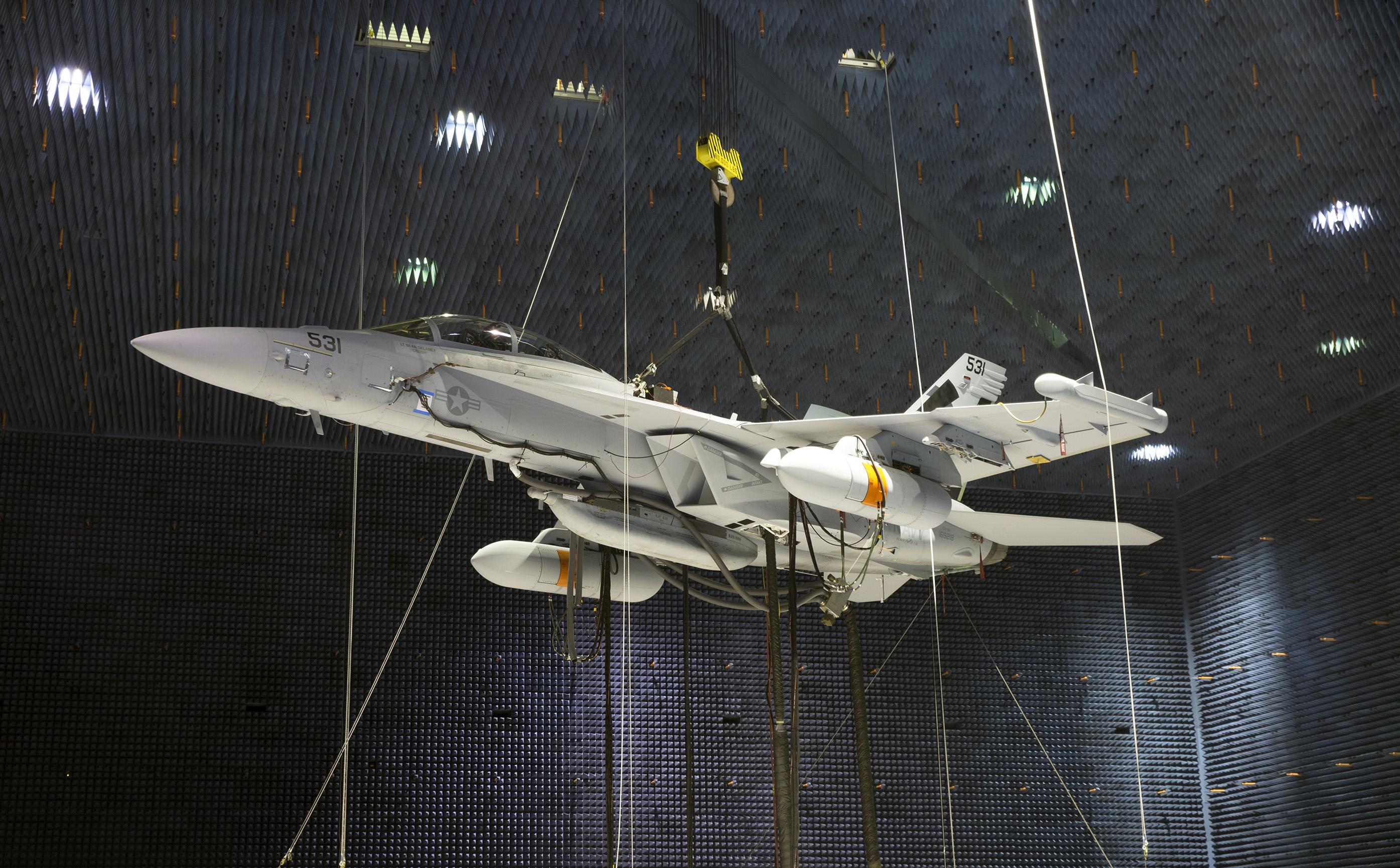Two Next Generation Jammer Mid-Band pods, attached to an EA-18G Growler, undergo testing in the Air Combat Environmental Test and Evaluation Facility anechoic chamber at Naval Air Station Patuxent River, Md. (U.S. Navy photo)