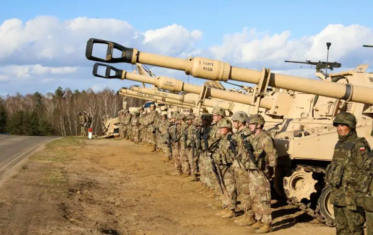 U.S. Army soldiers from 9th Brigade Engineer Battalion, 2nd Brigade Combat Team, stand alongside their Polish counterparts during a base visit at the Ziemsko Airfield, Poland, on March 11, 2020.