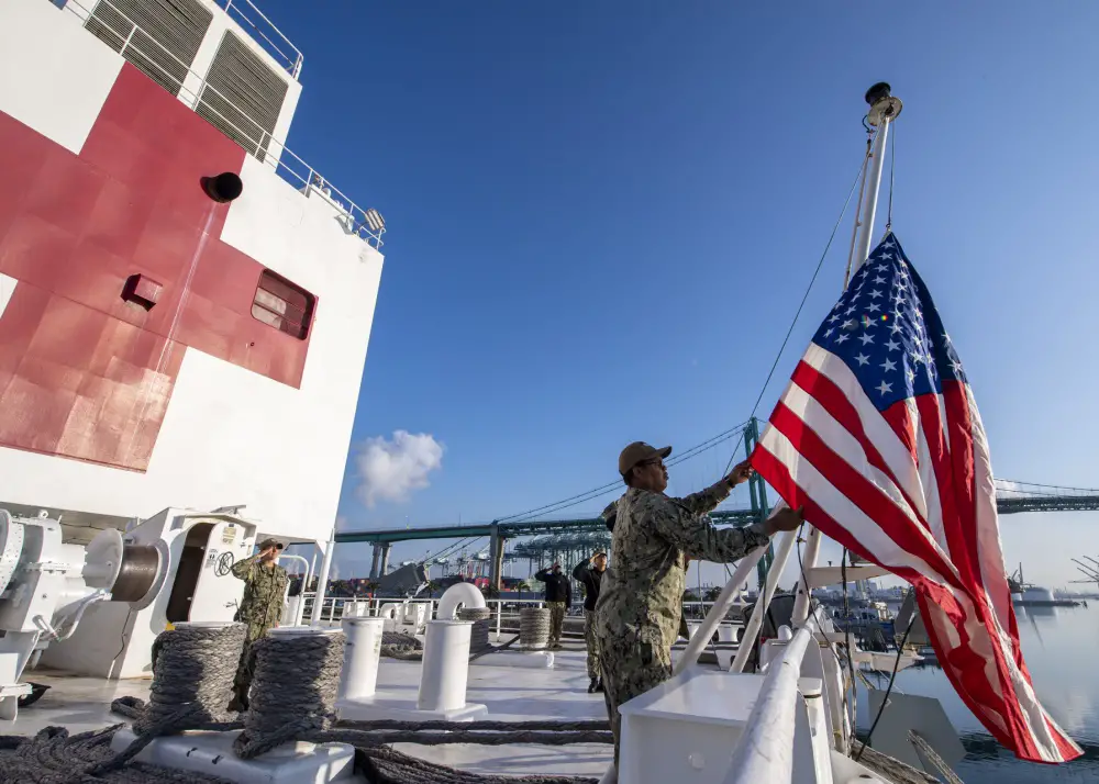 Logistics Specialist 1st Class Tavares Littleton, from Chicago, raises the National Ensign during morning colors aboard the hospital ship USNS Mercy (T-AH 19).   (U.S. Navy photo by Mass Communication Specialist 2nd Class Ryan M. Breeden)