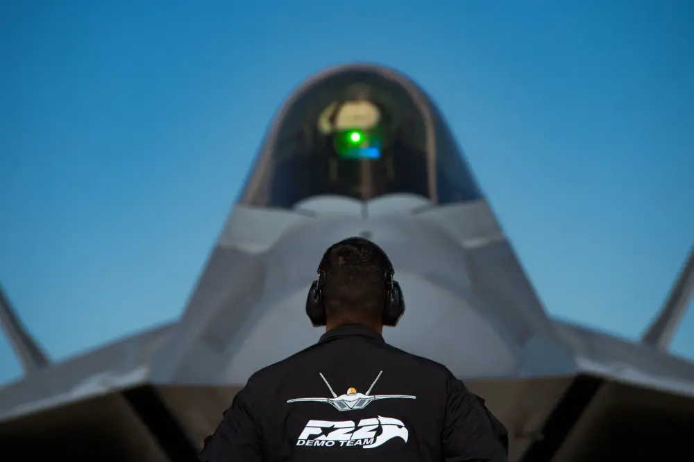 U.S. Air Force Senior Airman Carlos Paonessa, F-22 Demonstration Team dedicated crew chief, marshals Maj. Joshua Gunderson, F-22 Demonstration Team pilot, before takeoff during Air Force Heritage Flight Training Course attendees, at Davis-Monthan Air Force Base, Arizona, Feb. 29, 2020. The U.S. Air Force Heritage Flight program shows the evolution of U.S. Air Force air craft by flying today's fighter aircraft in formation with historical fighter aircraft. (U.S. Air Force photo by Senior Airman Tristan Biese)