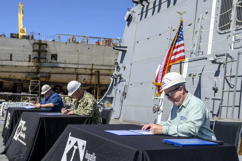 Donny Dorsey (right), Ingalls DDG 119 ship program manager; Commander Matthew McKenna (center), DDG 119 prospective commanding officer; and Peter T. Christman III, DDG 51 Project Office, SUPSHIP Gulf Coast, practice safe social distancing while signing the DD 250 transferring custody of Delbert Black (DDG 119) to the United States Navy on Friday, April 24, at Ingalls Shipbuilding in Pascagoula, Miss. 