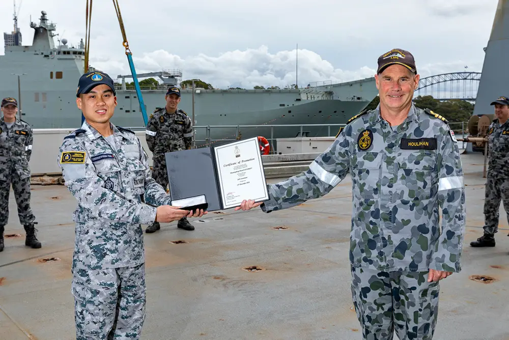 Midshipman Theeratiphong Pannil of the Royal Thai Navy is presented with a certificate of promotion to the rank of Sub Lieutenant by Commanding Officer HMAS Choules, Commander Scott Houlihan RAN, CSM at a ceremony held aboard HMAS Choules, Garden Island, Sydney.