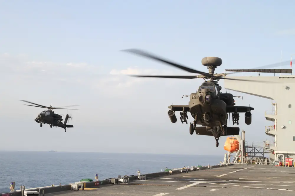 Two AH-64E Apache gunships take off from the U.S.S. Lewis B. Puller during an at sea training exercise on April 16, 2020 in the Persian Gulf. The U.S. Army and the U.S. Navy work together to not only train but also make both forces more effective. (U.S. Army photo by SGT. Andrew Winchell)