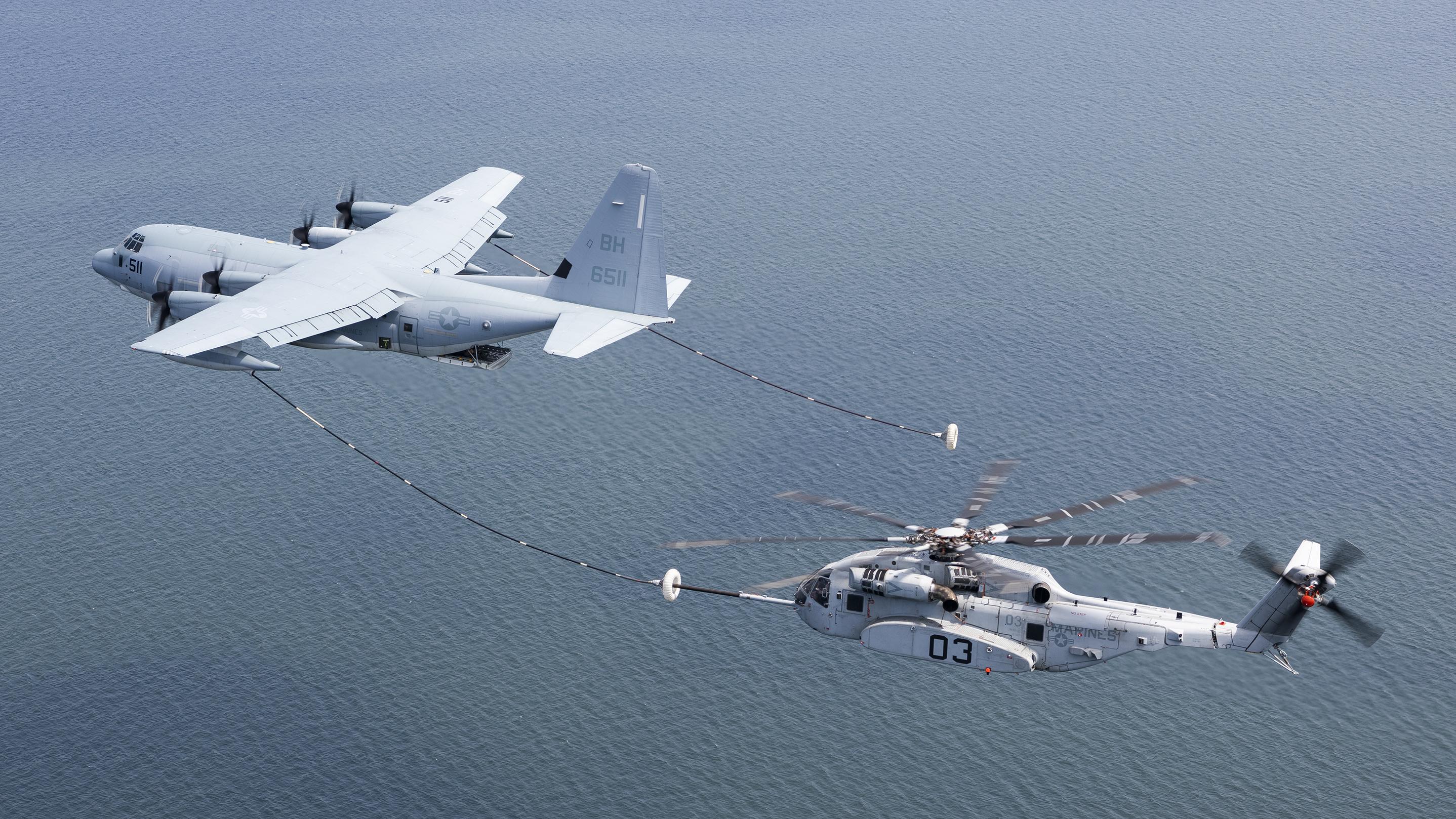 The CH-53K King Stallion successfully plugs into a funnel-shaped drogue towed behind a KC-130J during aerial refueling wake testing over the Chesapeake Bay. U.S. Navy Photo.s