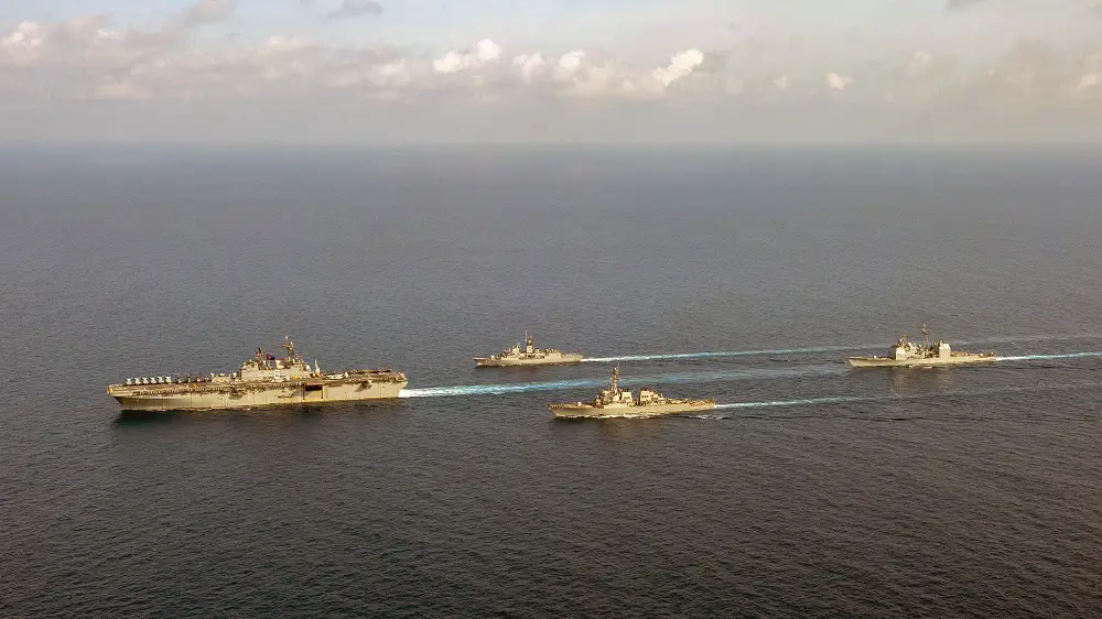 The amphibious assault ship USS America (LHA 6), left, sails with Royal Australian Navy guided-missile frigate HMAS Parramatta (FFH 154), Arleigh-Burke class guided missile destroyer USS Barry (DDG 52) and Ticonderoga-class guided-missile cruiser USS Bunker Hill (CG 52). Bunker Hill is deployed to the U.S. 7th Fleet area of operations and is operating with the America Expeditionary Strike Group in support of security and stability in the Indo-Pacific region.