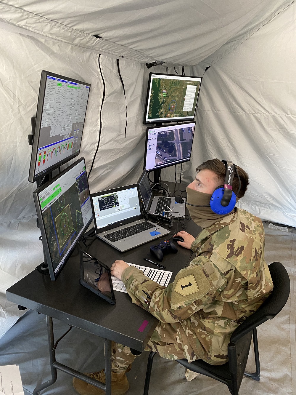 Spc. Nicholas Miller assigned to 1st Engineer Battalion, 1st Infantry Division, conducts flight operations through a laptop based ground control station during the FTUAS capabilities assessment at Fort Riley, Kansas, April 8, 2020 (Photo Credit: Program Executive Office Aviation )