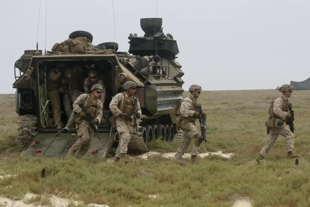 Marines assigned to Golf Company, Battalion Landing Team 2/8, 26th Marine Expeditionary Unit (MEU), exit an assault amphibious vehicle during an amphibious raid training evolution on Karan Island, Saudi Arabia, April 20, 2020. The Bataan Amphibious Ready Group and 26th MEU are conducting routine sustainment training in the U.S. 5th Fleet area of operations in order to enhance the Navy-Marine Corps team's ability to employ low-signature, operationally relevant and strategically mobile crisis response forces to project power over key maritime terrain. (U.S. Marine Corps photo by Staff Sgt. Pablo Morrison)