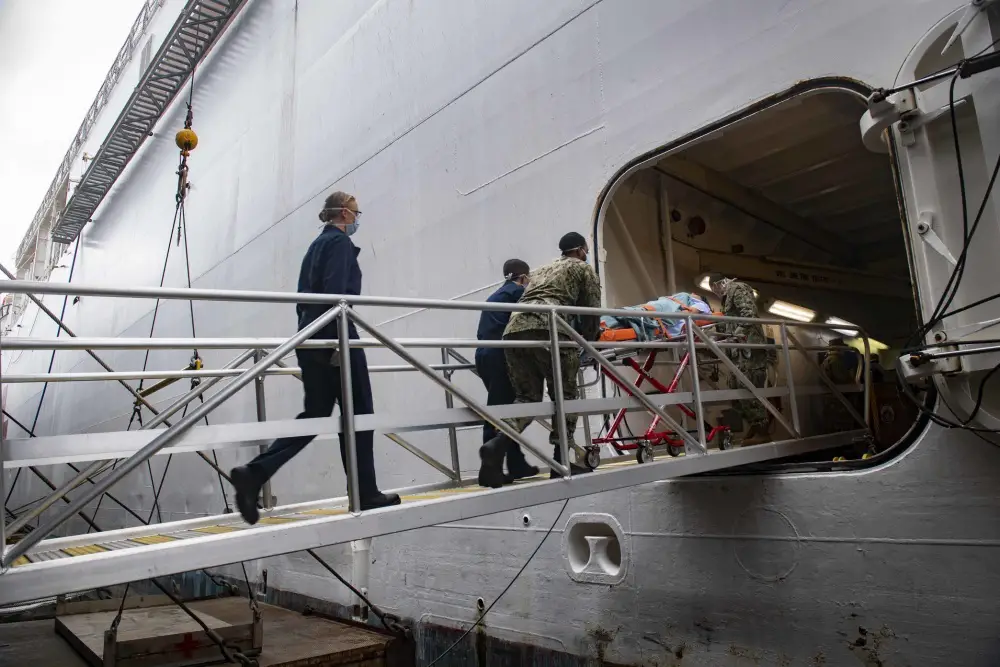 - US Navy Sailors practice patient transfer from the pier onto the hospital ship USNS Comfort (T-AH 20) as they prepare to admit patients in support of the nation's COVID-19 response efforts.