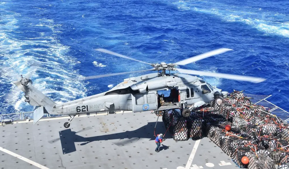 An MH-60S Sea Hawk helicopter prepares to lift supplies from the flight deck of the Lewis and Clark-class dry cargo and ammunition ship USNS Richard E. Byrd (T-AKE 4) during a replenishment-at-sea with U.S. 7th Fleet flag ship USS Blue Ridge (LCC 19). (U.S. Navy photo by Charles Baker)