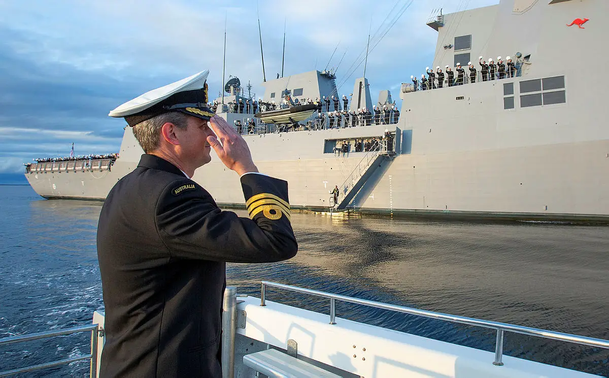 Commanding Officer HMAS Sydney, Commander Edward Seymour, RAN salutes his crew inside Jervis Bay, NSW following the ship's commissioning ceremony at sea. (Photo by Royal Australian Navy/POIS Tom Gibson)
