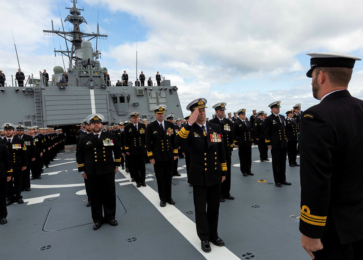 Chief of Navy, Vice Admiral Michael Noonan AO, RAN salutes the parade commander, Executive Officer HMAS Sydney, Lieutenant Commander Bernard Dobson, CSM, RAN during the ship's commissioning ceremony at sea off the coast of NSW. (Photo by Royal Australian Navy/POIS Tom Gibson)