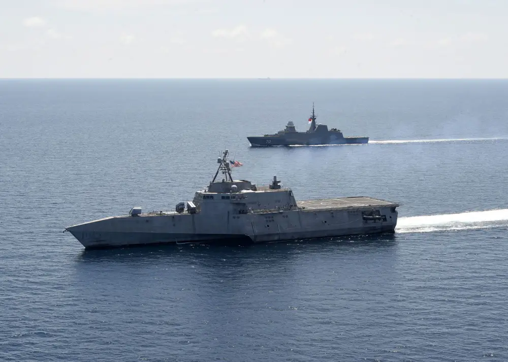 The Independence-variant littoral combat ship USS Gabrielle Giffords (LCS 10), left, exercises with the Republic of Singapore Navy Formidable-class multi-role stealth frigate RSS Steadfast (FFS 70) in the South China Sea, May 25, 2020. 