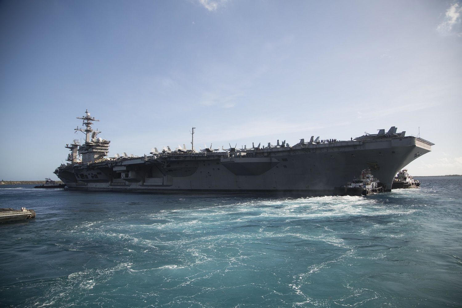 The aircraft carrier USS Theodore Roosevelt (CVN 71) departs Apra Harbor following an extended visit to Guam in the midst of the COVID-19 global pandemic. Theodore Roosevelt is underway conducting carrier qualifications during a deployment to the Indo-Pacific. (U.S. Marine Corps photo by Staff Sgt. Jordan E. Gilbert/Released)