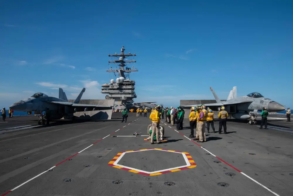 An F/A-18E Super Hornet attached to Strike Fighter Squadron (VFA) 115, left, and an F/A-18E Super Hornet attached to Strike Fighter Squadron (VFA) 27 prepare to launch on the flight deck of the U.S. Navy's only forward-deployed aircraft carrier USS Ronald Reagan (CVN 76). (U.S. Navy photo by Mass Communication Specialist 2nd Class Samantha Jetzer)