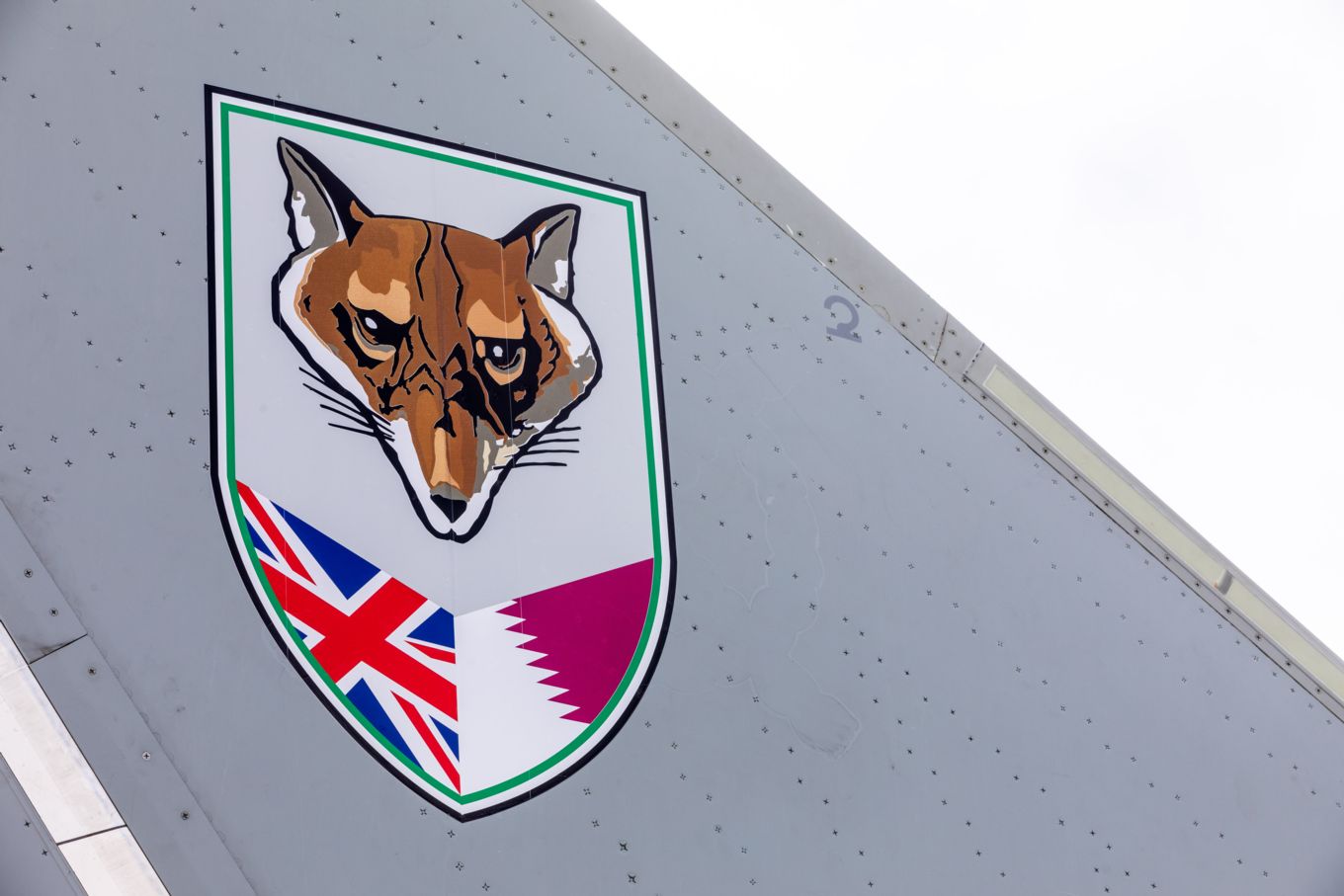 The badge of No. 12 Squadron, a unique joint unit combining Typhoon aircraft operated by the Royal Air Force and the Qatar Emiri Air Force, painted on the tail fins of the unit's Eurofighter Typhoon fighters. 