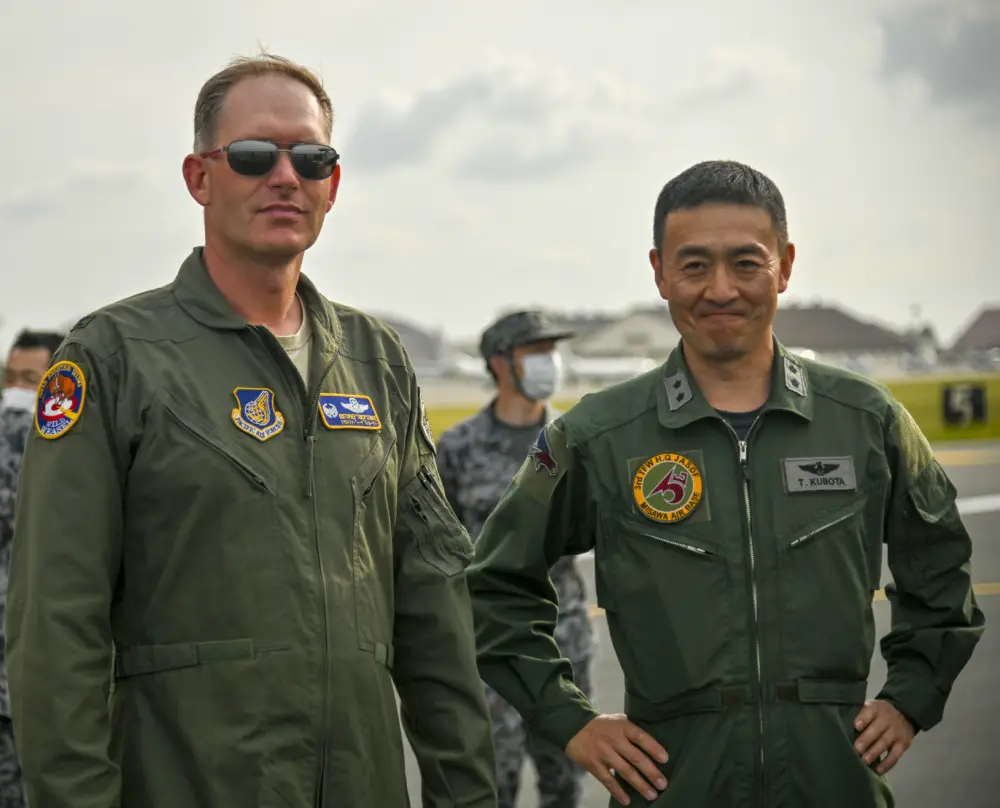  U.S. Air Force Col Kristopher Struve, left, 35th Fighter Wing commander, and Koku-Jieitai Maj. Gen. Takahiro Kubota, 3rd Air Wingcommander, watch as aircraft taxi into position for an 