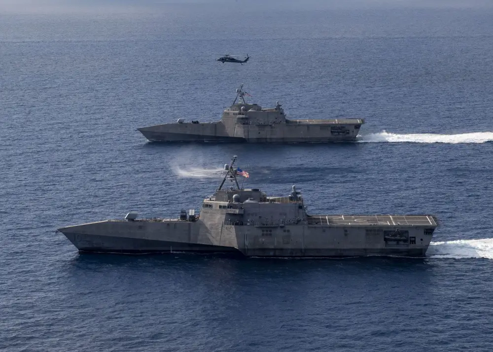 The Independence-variant littoral combat ships USS Gabrielle Giffords (LCS 10), bottom, and USS Montgomery (LCS 8) operate in the South China Sea, accompanied by an MH-60S Sea Hawk of Helicopter Sea Combat Squadron (HSC)