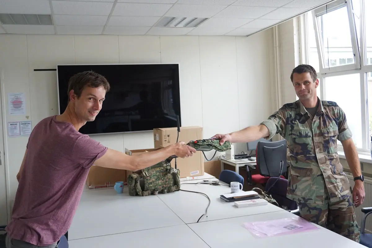 Elitac Wearables' Wouter Vos (l) hands over first Mission Navigation Belt order to Major Van Veen, Defence Centre of Expertise for Soldier and Equipment, Royal Netherlands Army (r), under COVID-19 distance rules