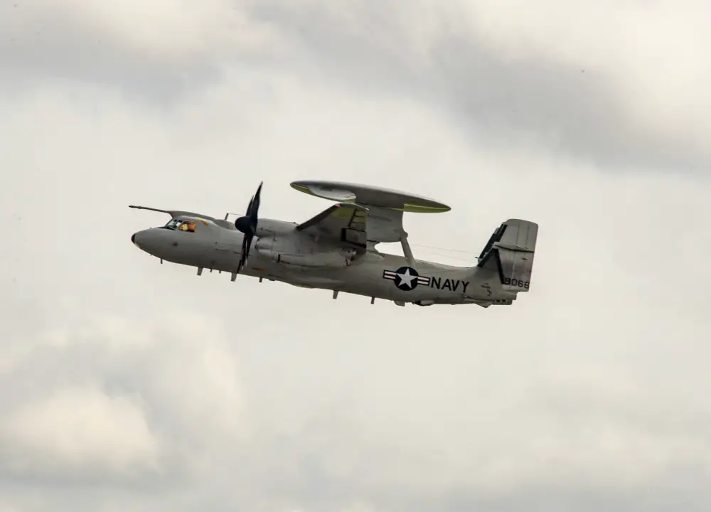 An E-2D Hawkeye prepares to land and be recieved by the 
