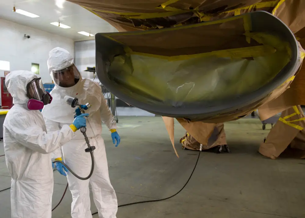 Senior Airman Nicolas Pages, 56th Equipment Maintenance Squadron aircraft structural maintenance journeyman (left), prepares to paint the inlet lip of an F-16C Fighting Falcon while Airman 1st Class Justin Beverly, 56th EMS Low Observable ASM apprentice, assists June 22, 2020, at Luke Air Force Base, Ariz.
